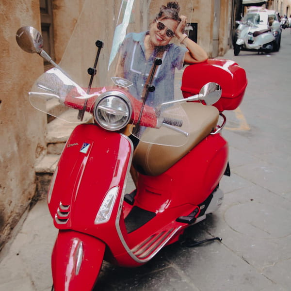 Picture of Cherine with a red scooter